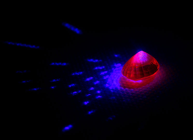 Let it glow Ruby (and red spinel) is unusual in that it can take blue light and re-emit it as red fluorescence. This separates ruby (and spinel) from other red stones, such as garnet.